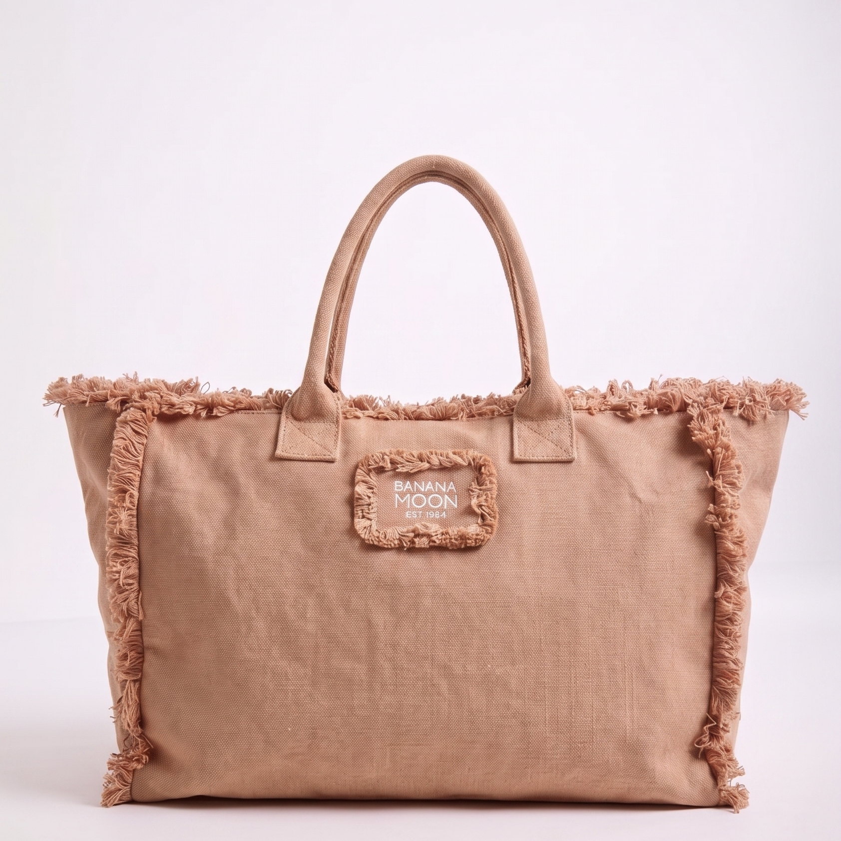 Beige tote bag with frayed edges on a white background