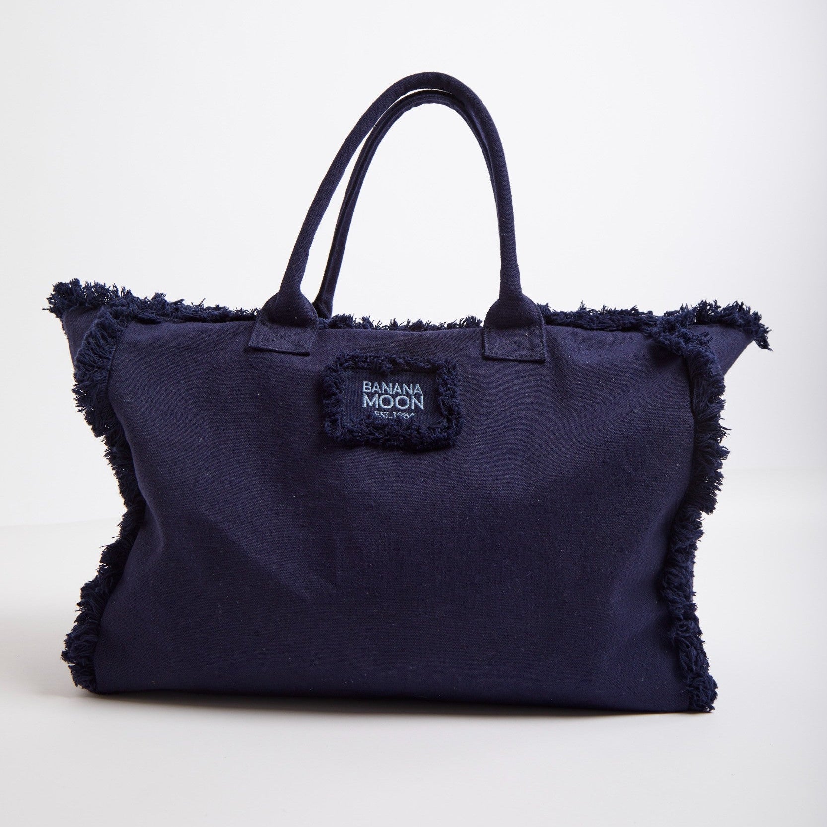 Navy blue handbag with frayed edges on a white background